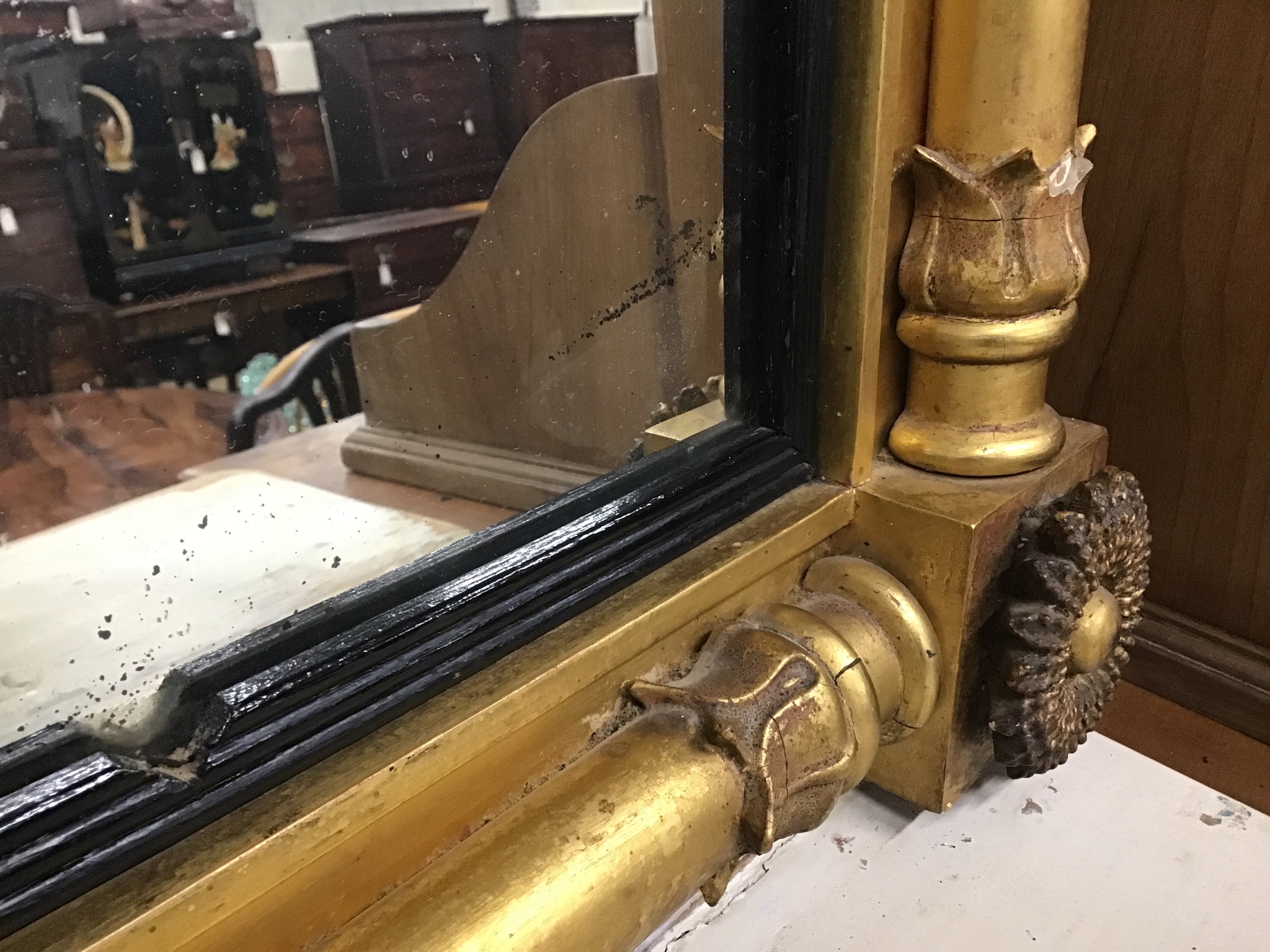 A William IV giltwood and composition overmantel mirror with ebonized slip width 106cms, height 68cms.